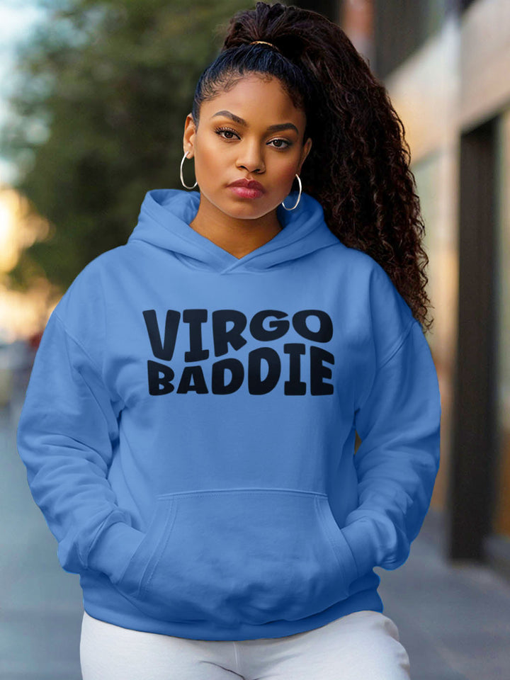 Woman wearing a carolina color custom graphic hoodie with bold black text design artwork that reads “VIRGO BADDIE” in large, playful bubble style block letters. 