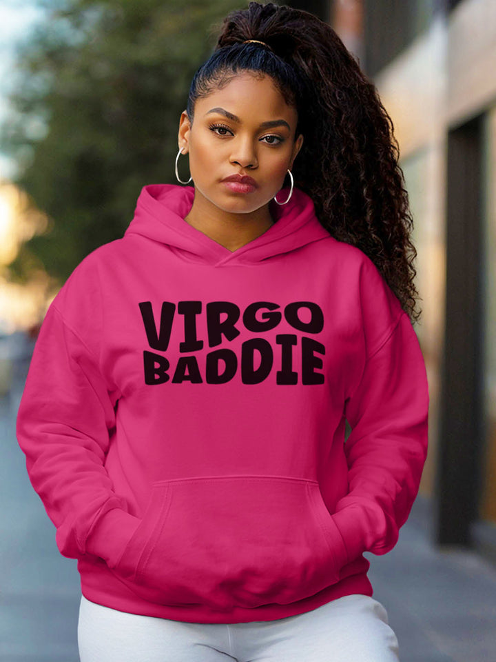 Woman wearing a fuchsia color custom graphic hoodie with bold black text design artwork that reads “VIRGO BADDIE” in large, playful bubble style block letters. 